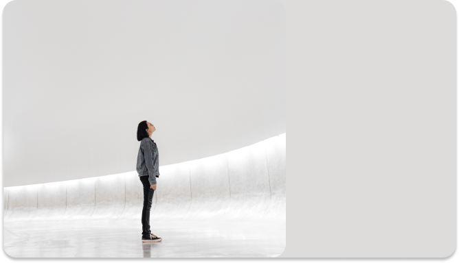 A woman gazes upwards, symbolizing her forward-thinking mindset towards innovation.